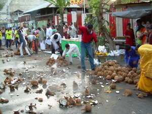 Coconuts breaking to clean the roads for Lord Muruga Thaipusam Penang