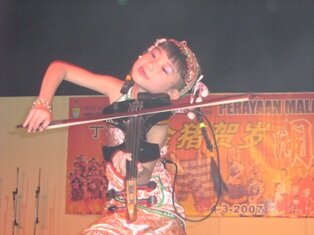 Young enthusiastic violinist during chap goh meh in Penang
