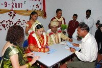 Uvaraani signing the papers in Hindu Wedding