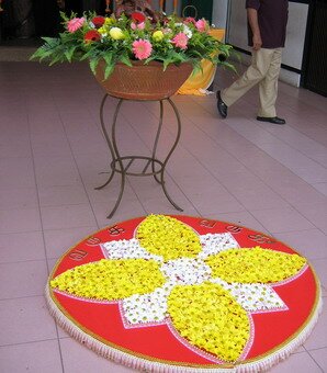 Plastic flowers and lace kolam