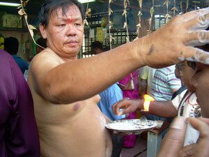 chinese mediums blessing the devotee during thaipusam penang